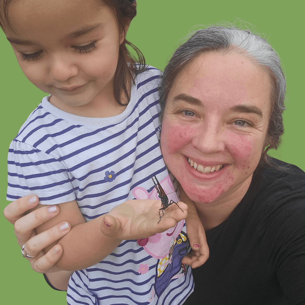 Melanie and her daughter holding an insect